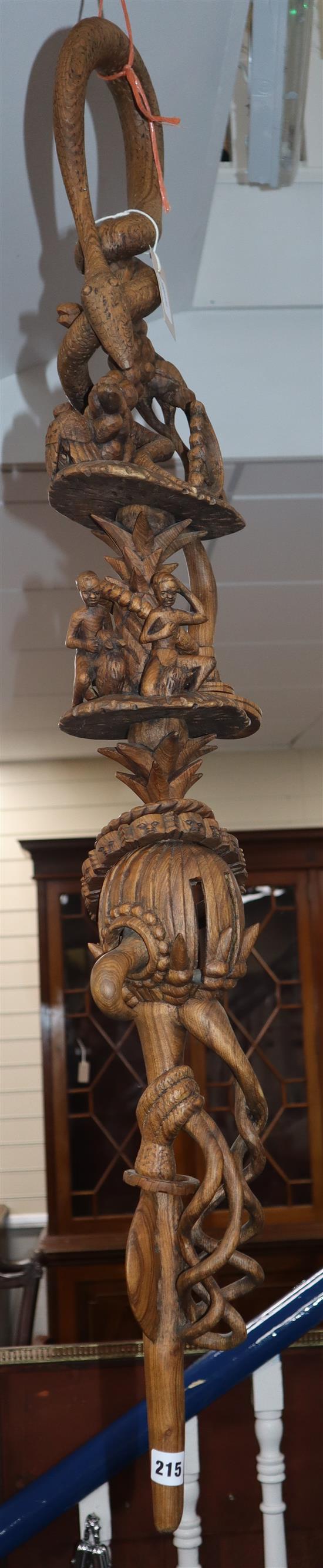 Zimbabwe, a Nyami-Nyami walking stick, carved with snake handle, figures, trees and other motifs, titled H 120cm